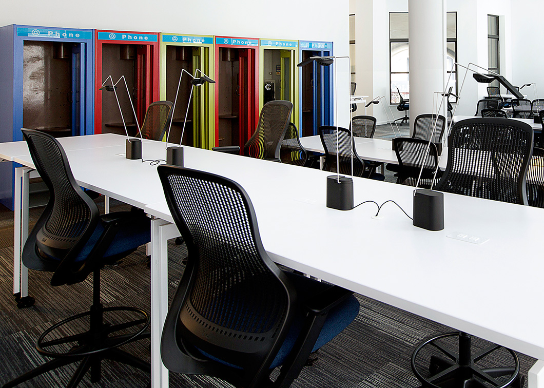 Bright white tabletops enhance the spacious feeling experienced with the building’s open layout, white walls, high ceilings and generous natural daylight. | Featured: ReGeneration by Knoll Work and High Task Chairs, Antenna Workspace Tables, Sparrow Desktop Lights